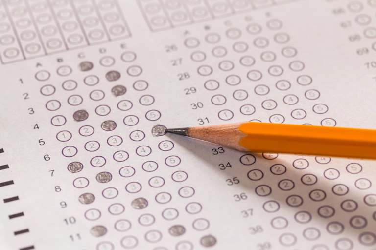 Pencil resting on a paper exam sheet.