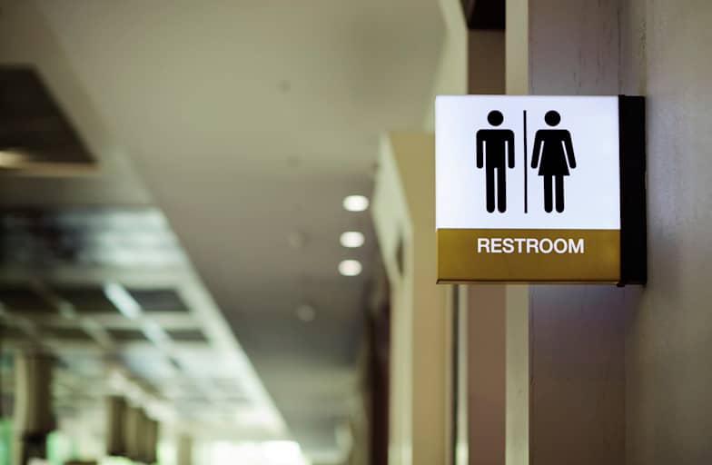 Sign at the entrance of a public restroom in a school building.