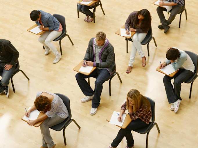 High school students taking the SAT test in a classroom.