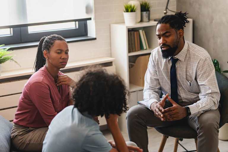Woman with teen son have a meeting with the school counselor