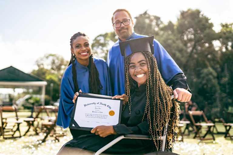 Teacher and student showing diploma at graduation