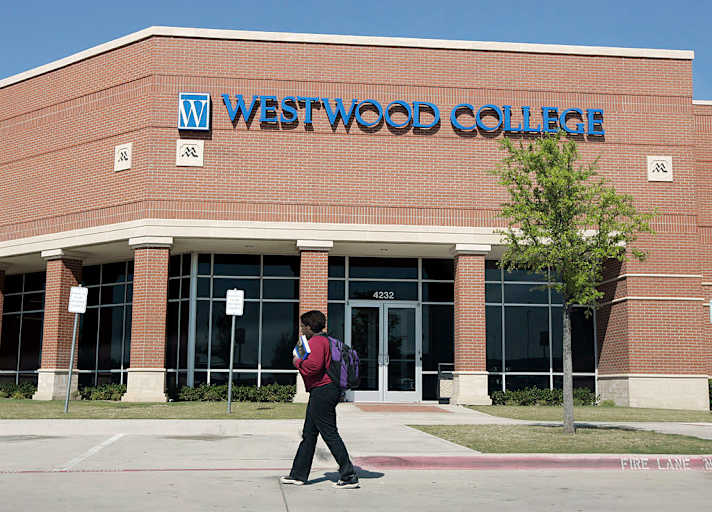 A student walks to class on the Westwood College campus in Fort Worth, Texas, on a sunny day.