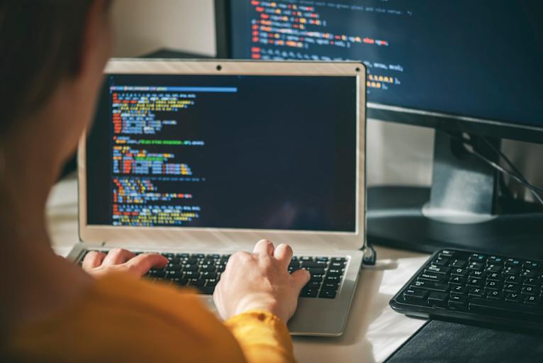 Close up of woman programmer working at home in home office