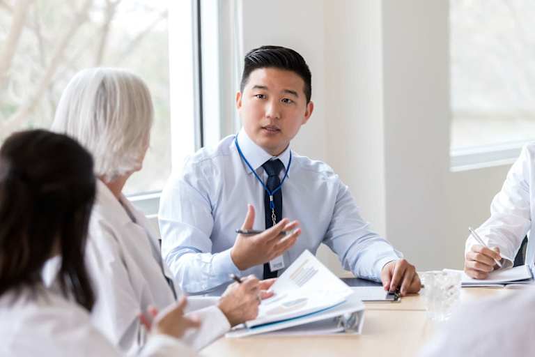Serious hospital executive talks during meeting