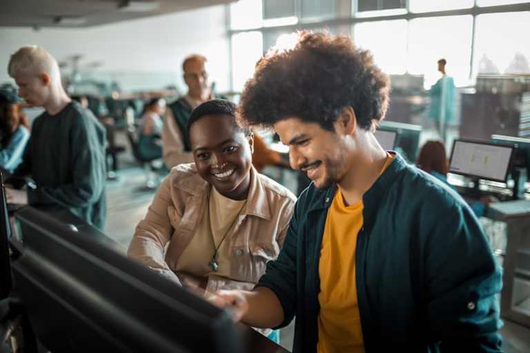 Close up of a group of students in the university working on their computers