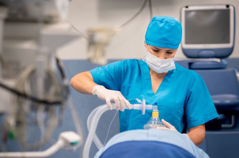 Nurse administering anesthesia to a patient