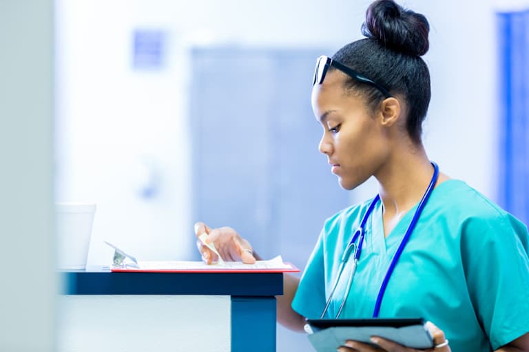 Nurse checking clipboard in emergency room