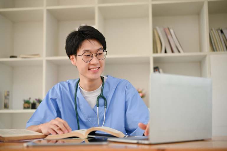 Nurse working on a laptop in the library
