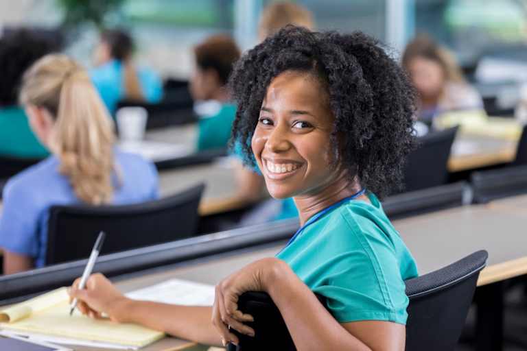 Nursing student takes notes in class