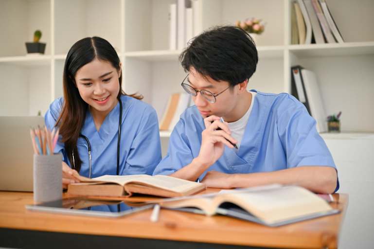 Nursing students studying together in the library