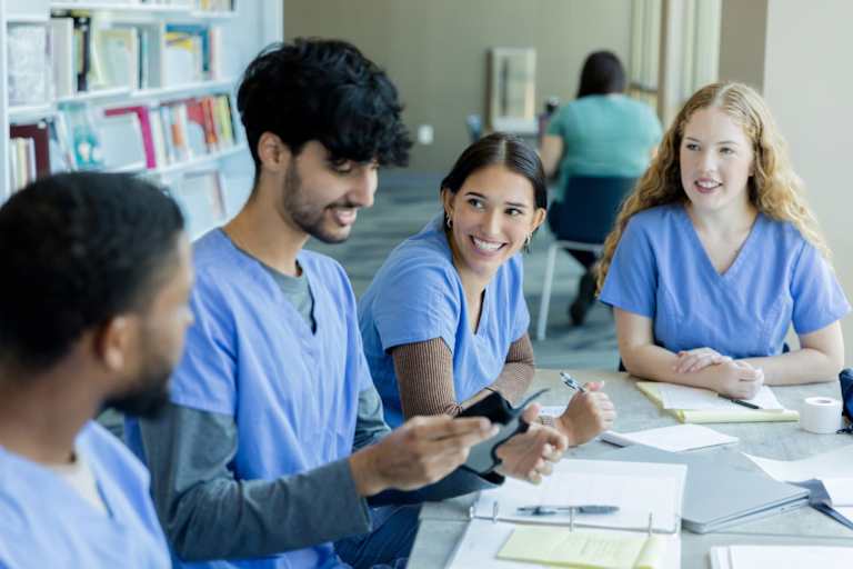 Nursing students learning to put on a wrist brace in class