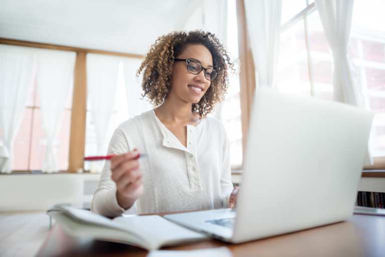 Woman studying on laptop at home