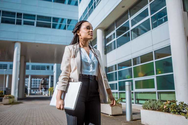 Healthcare professional walking outside of hospital