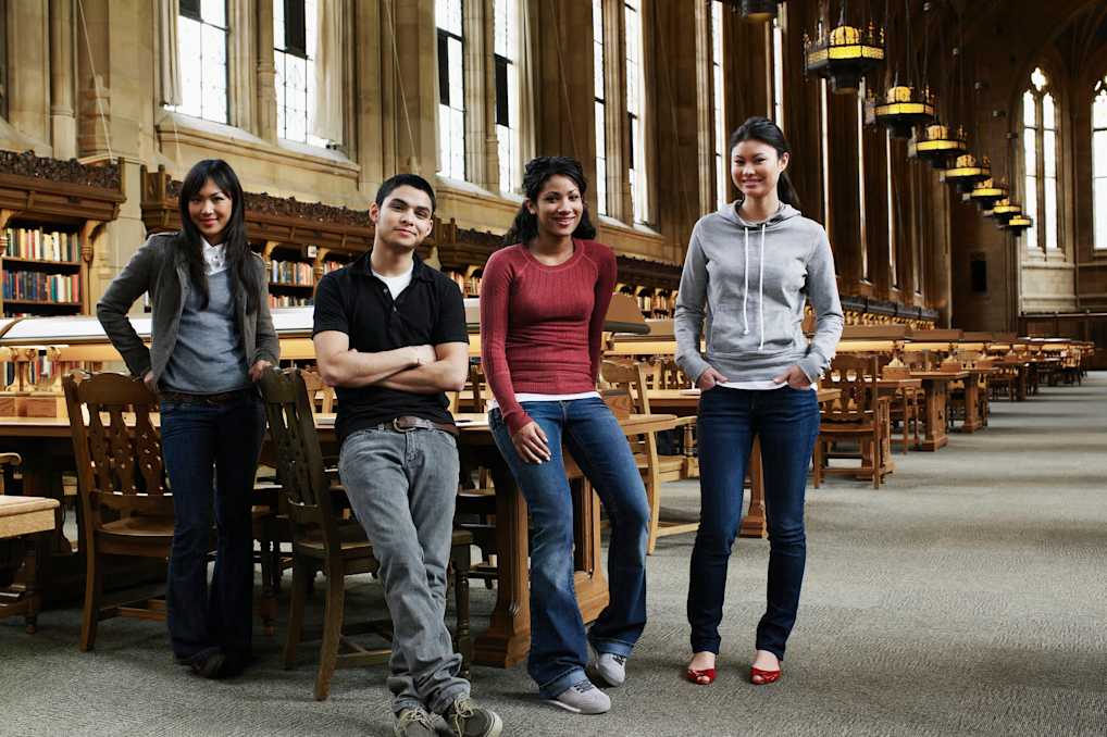 University students in library, smiling