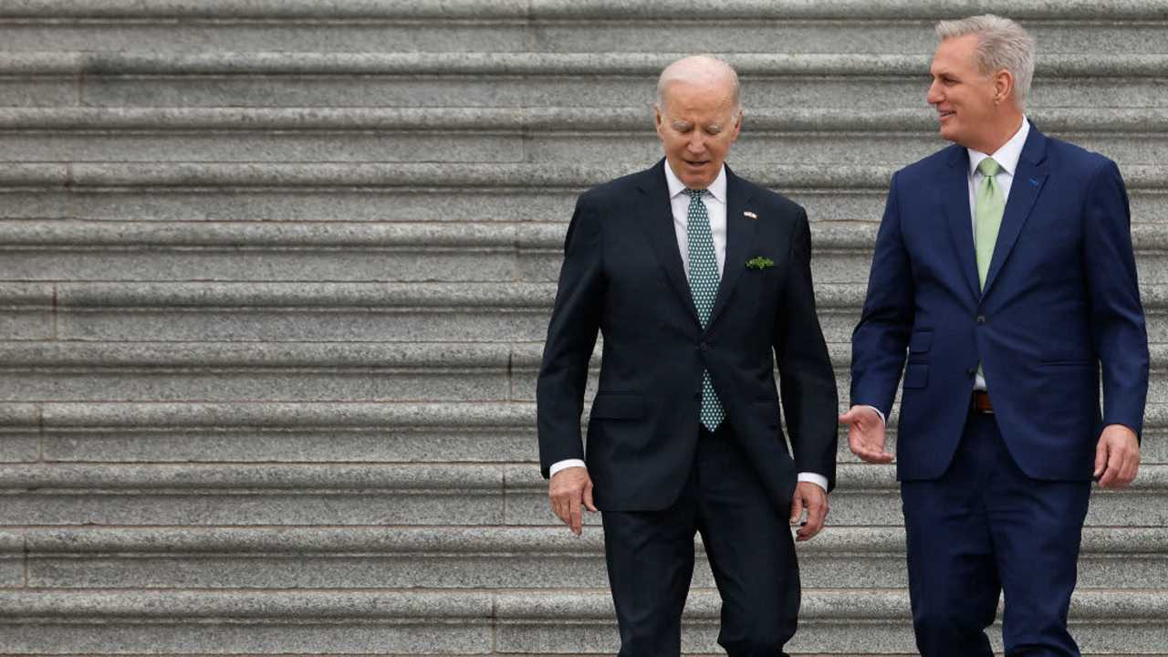 President Joe Biden and Speaker of the House Kevin McCarthy talk while walking out of the US Capitol