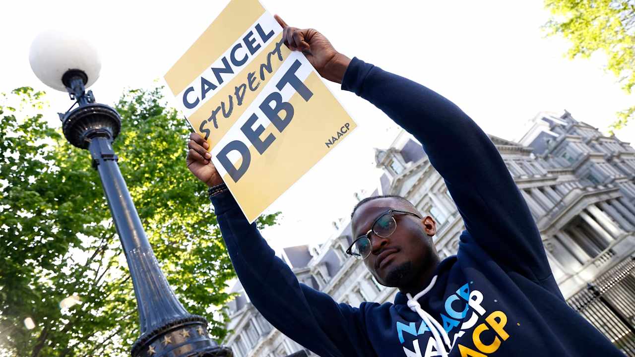 Wisdom Cole of the NAACP joins student debtors to once again call on President Biden to cancel student debt at an early morning action outside the White House