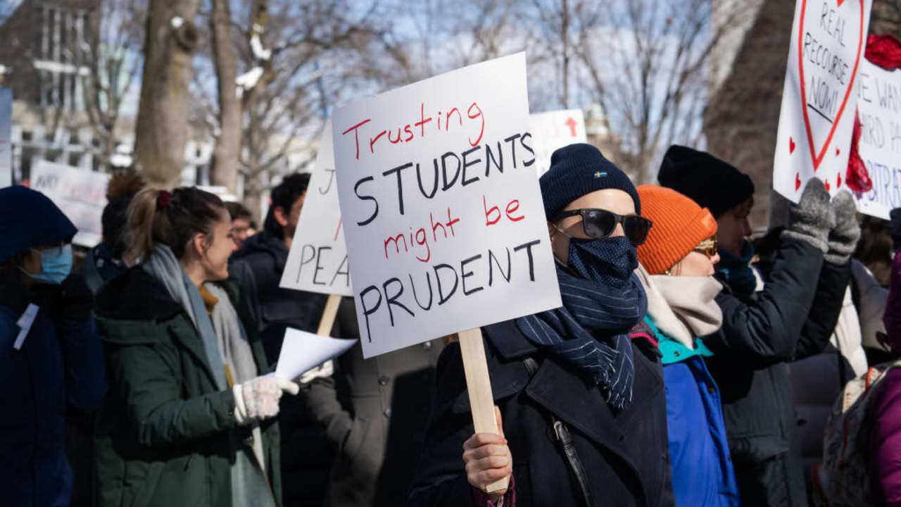 A demonstrator holds a sign during a 'No Justice Walkout' protest at Harvard University in Cambridge, Massachusetts, U.S., on Monday, Feb. 14, 2022. Harvard allowed a star professors sexual abuse of female students to continue unchecked for decades, contributing to a culture of harassment in its Anthropology Department, a new lawsuit alleges. Harvard University disputes the allegations of the lawsuit. Photographer: Vanessa Leroy/Bloomberg via Getty Images