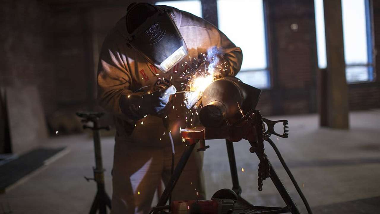 BOSTON, MA - OCTOBER 2: A welder works on a pipe fitting at the new Fraunhofer Building Technology Showcase October 2, 2012 under construction in the Innovation District of Boston, Massachusetts. Included in the building will be the Fraunhofer Center for Sustainable Energy Systems, a testing area for building related industrial firms testing their new systems of sustainable technologies, materials and concepts and monitored by Fraunhofer's Research & Design engineers. Part of the testing facility will include a Building Energy Efficiency Group which works to accelerate development of the next-generation of energy-saving building technologies and practices. The Fraunhofer Institute is Europe's largest applied research organization with over 20,000 staff and offices in Europe, U.S.A., Asia and the Middle East. (Photo by Robert Nickelsberg/Getty Images)