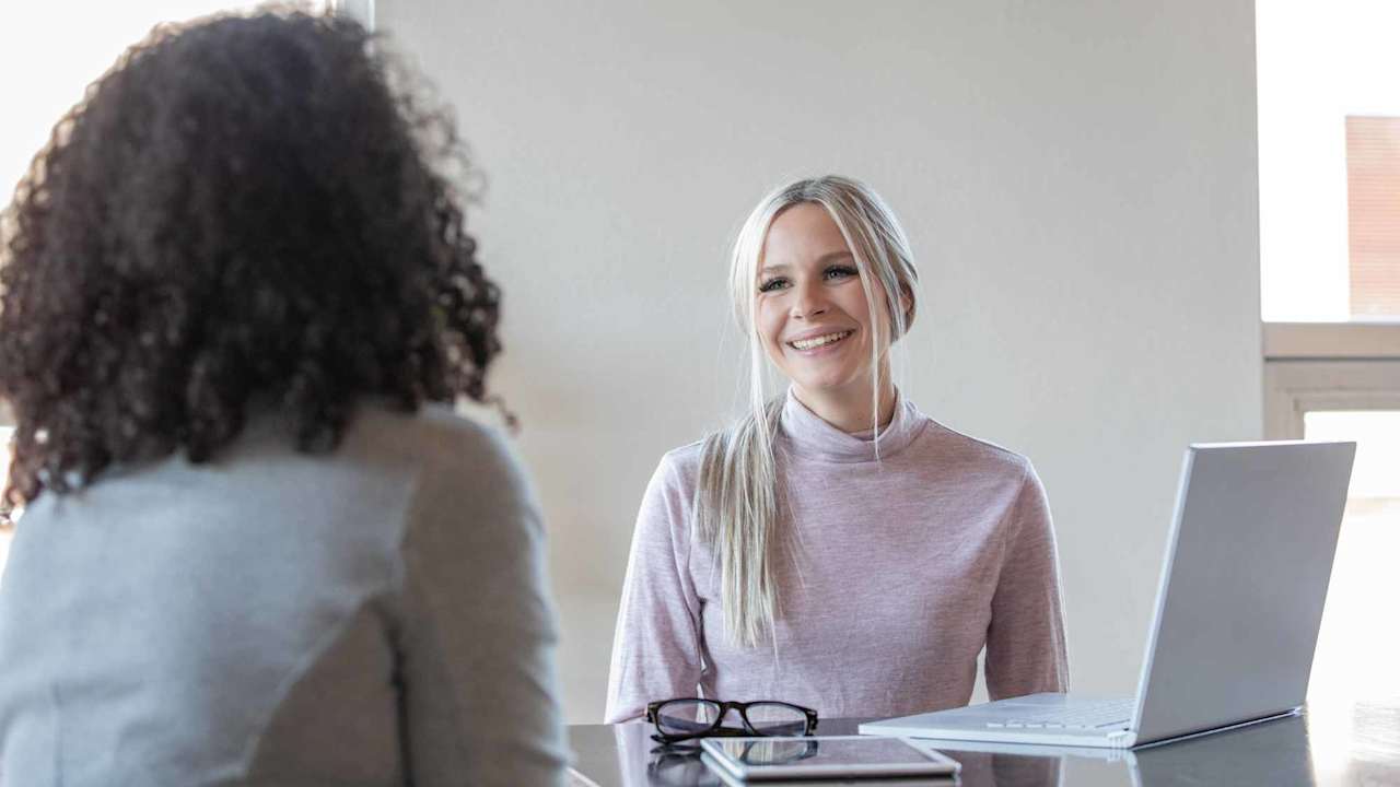 College student meeting with a college financial aid counselor in a university campus office.