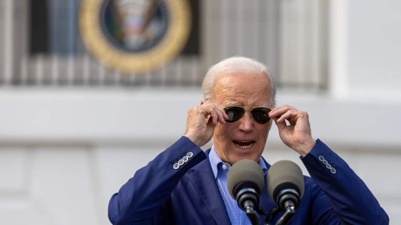 President Biden adjusting his sunglasses