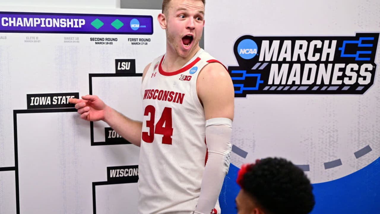 MILWAUKEE, WI - MARCH 18: Brad Davison #34 of the Wisconsin Badgers gestures to the bracket at their next opponent, the Iowa State Cyclones, after their win against the Colgate Raiders during the first round of the 2022 NCAA Men's Basketball Tournament held at the Fiserv Forum on March 18, 2022 in Milwaukee, Wisconsin. (Photo by Ben Solomon/NCAA Photos via Getty Images)