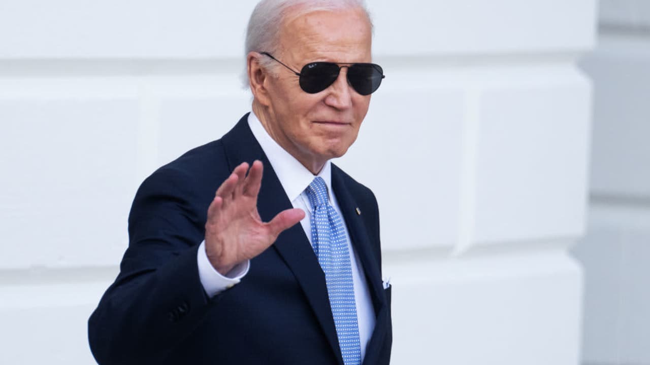 President Joe Biden waves to press members while walking to a helicopter en route to Wilmington, Delaware, on the White House lawn after the Presidential Medal of Freedom ceremony on May 3, 2024.