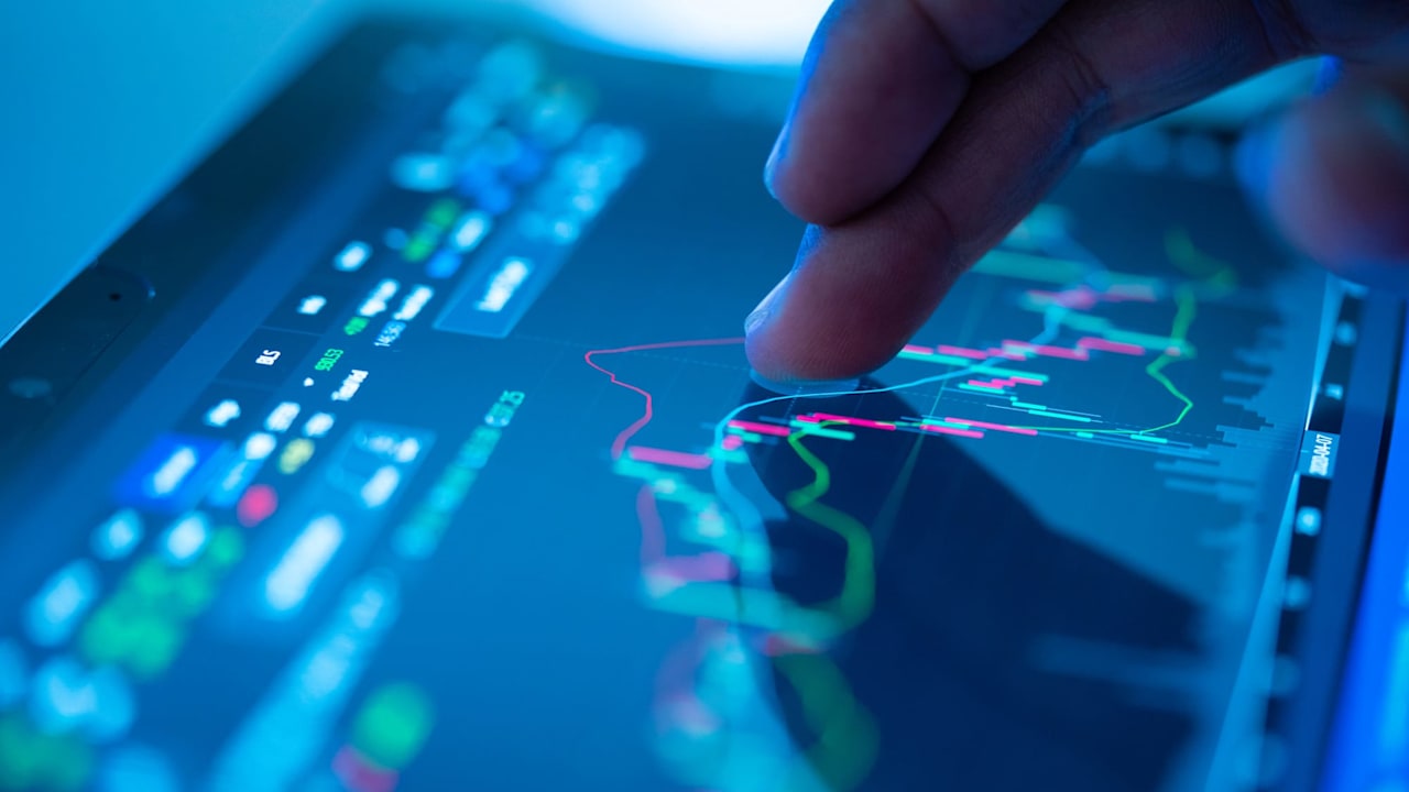 Businessman checking stock market data on tablet
