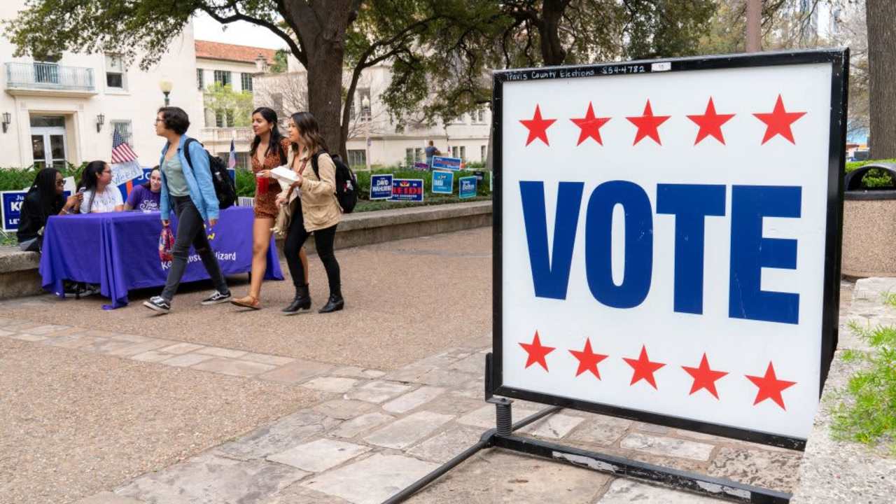 Students from the University of Texas in Austin walk in the square during a primary vote in Austin, Texas.