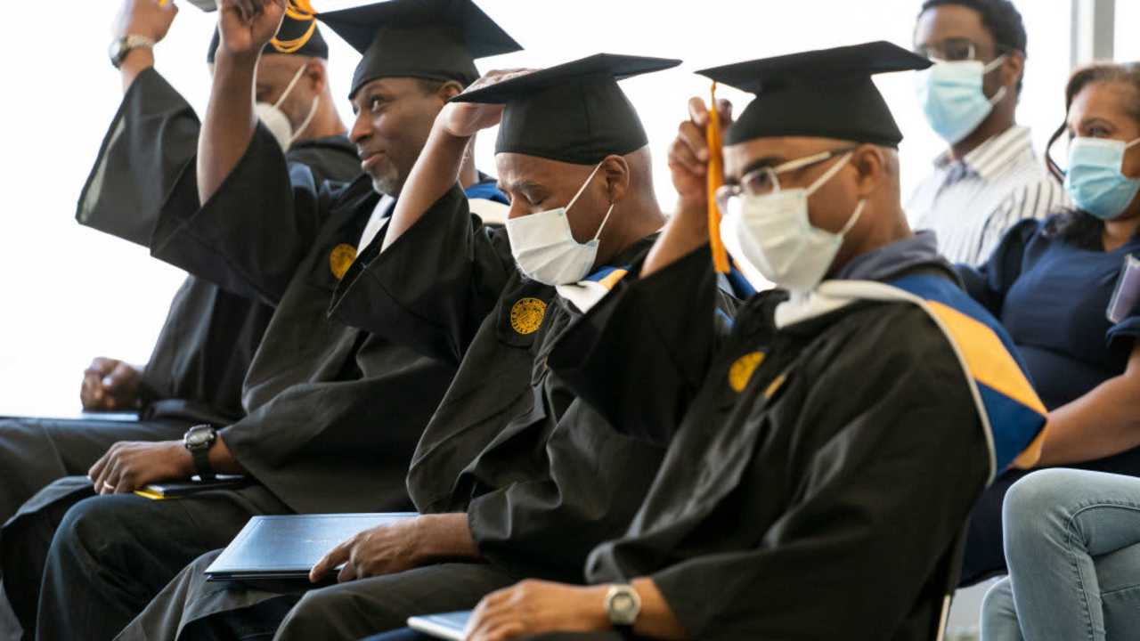 Graduates of the Goucher Prison Education Program for 2021 and 2022 move their tassels during the graduation ceremony held at the Maryland Correctional Institution-Jessup in Jessup, MD on May 18, 2022. James Scott, Nyol Robinson, James Jackson and Walter L. McCoy, Jr. received their degrees in American Studies from Goucher College while serving time in prison.