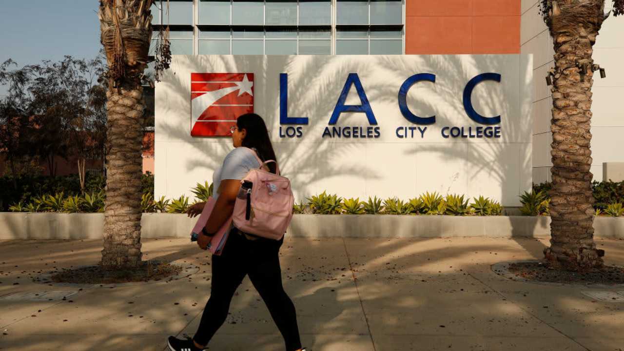 A student walking to class on the Los Angeles City College (LACC) campus.