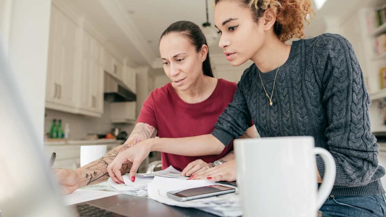 Mother and daughter filling out the FAFSA form for college student loans.