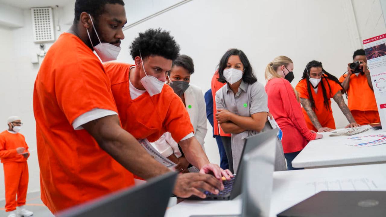 Students from the Brave Behind Bars program, an introductory computer science program for incarcerated people, gather for graduation at the DC Jail