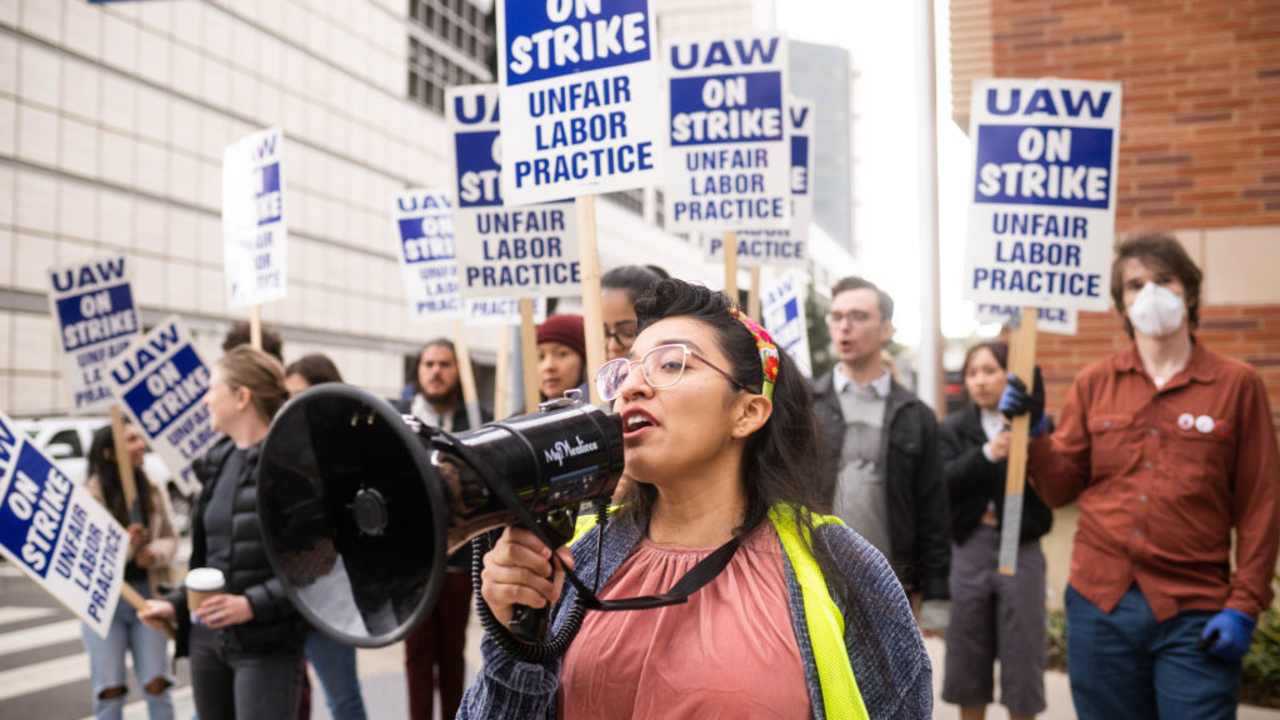 Gloria Bartolo, a 2nd year molecular biology PhD student, leads UCLA postdoctoral scholars and academic researchers on a strike through Westwood, Los Angeles, as they demand better wages, student housing, and child care from the University of California on December 1, 2022.