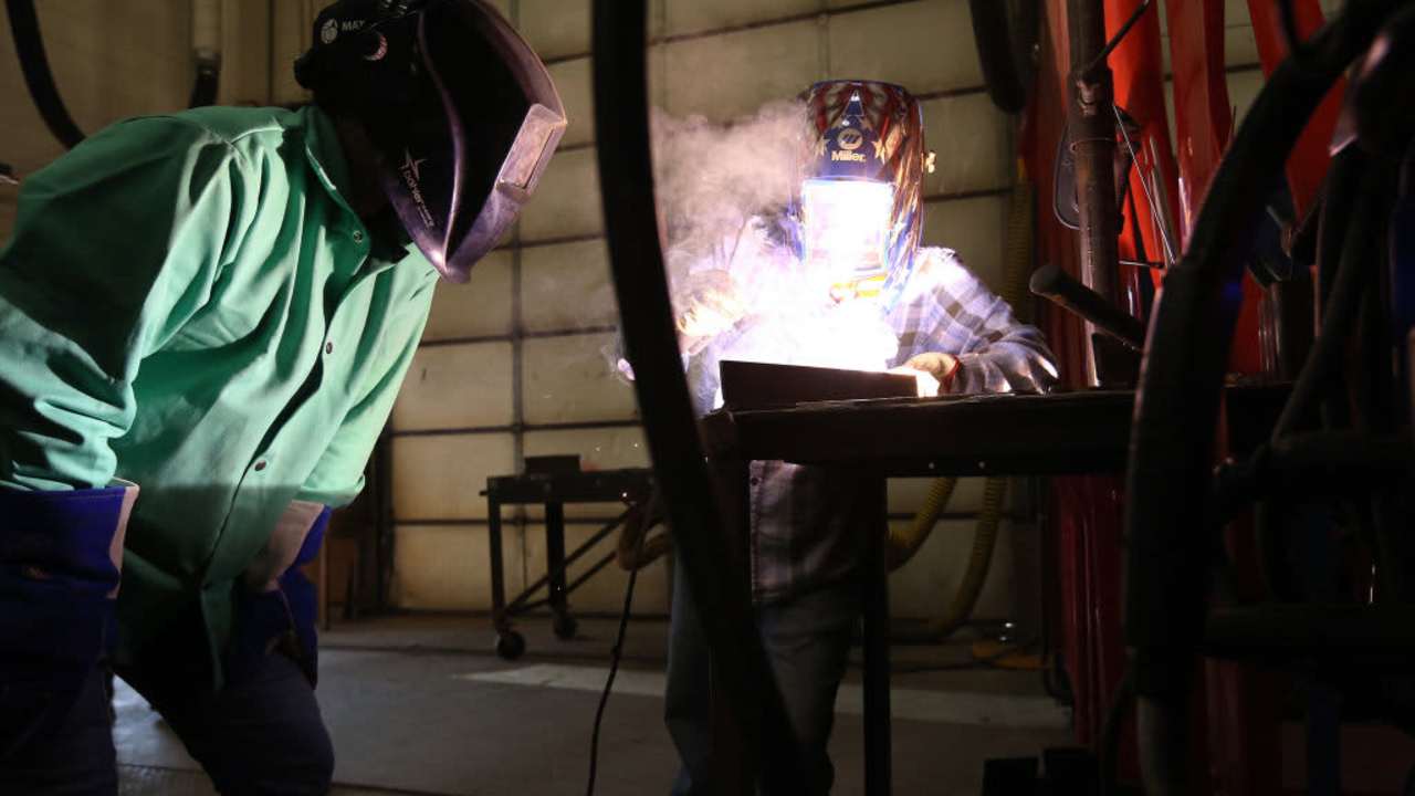 Lead instructor Penni Barbeau demonstrates welding techniques for student Audria Ariza at Southern Maine Community College's Midcoast Campus. Maine community colleges are receiving $1 million to buy a mobile welding lab. The lab will allow the community college system to extend its welding instruction throughout the state.