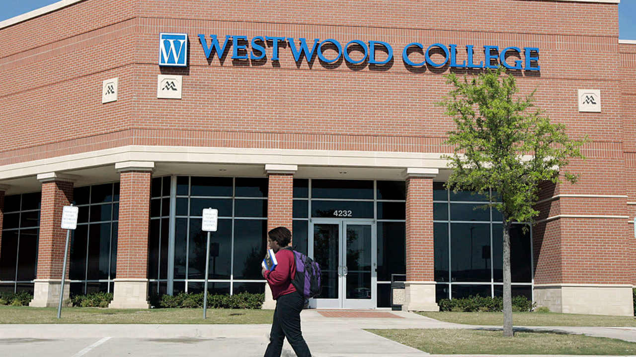 A student walks to class on the Westwood College campus in Fort Worth, Texas, on a sunny day.