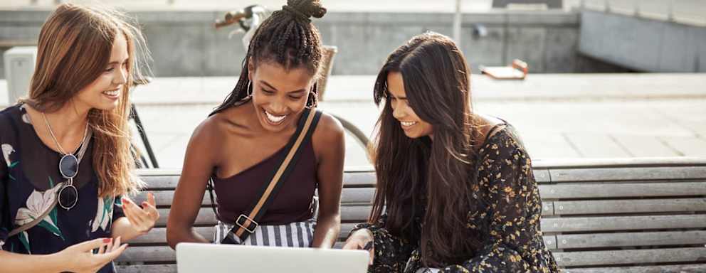 Shot of young women studying together outdoors
