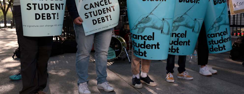 WASHINGTON, DC - APRIL 27: Activists hold signs as they attend a Student Loan Forgiveness rally on Pennsylvania Avenue and 17th street near the White House on April 27, 2022 in Washington, DC. Student loan activists including college students held the rally to celebrate U.S. President Joe Biden's extension of the pause on student loans and also urge him to sign an executive order that would fully cancel all student debt.