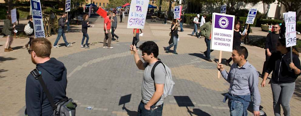 Teaching assistants, tutors and their supporters chant slogans and march during a union protest at the University of California, Irvine.