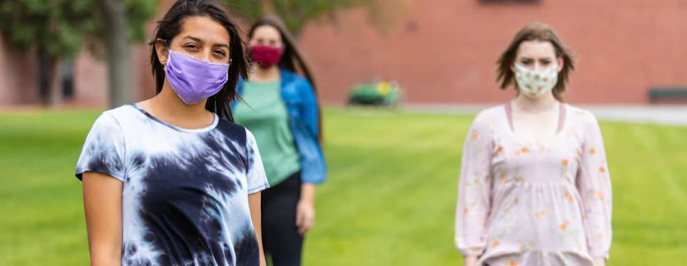 Group of Generation Z Multi-Ethnic Female Friends Wearing Face Masks and Social Distancing