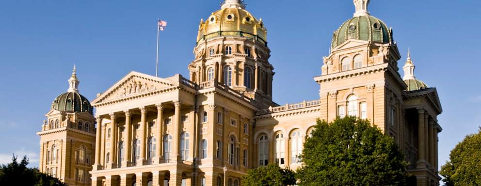 The gold leaf dome of the Iowa State Capitol glows in the evening sun.