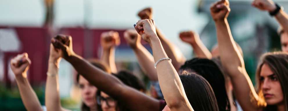 Protestors raising fists high above heads. Concept of protest, human rights, fighting.