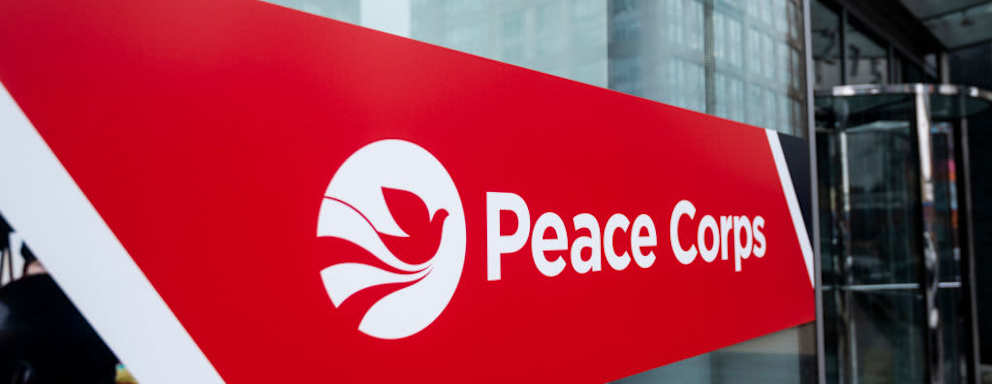 A sign marking the entrance to the Peace Corps headquarters in Washington, DC.