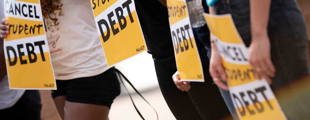 Activists hold cancel student debt signs as they gather to rally in front of the White House in Washington, DC, on August 25, 2022. - Biden announced on August 24, 2022, that most US university graduates still trying to pay off student loans will get $10,000 of relief to address a decades-old headache of massive educational debt across the country.