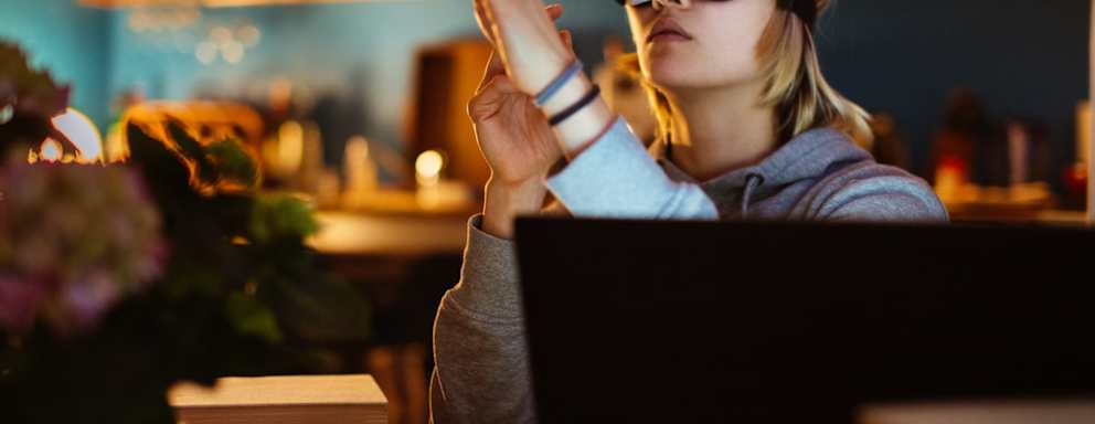 Woman using a virtual reality headset at home.