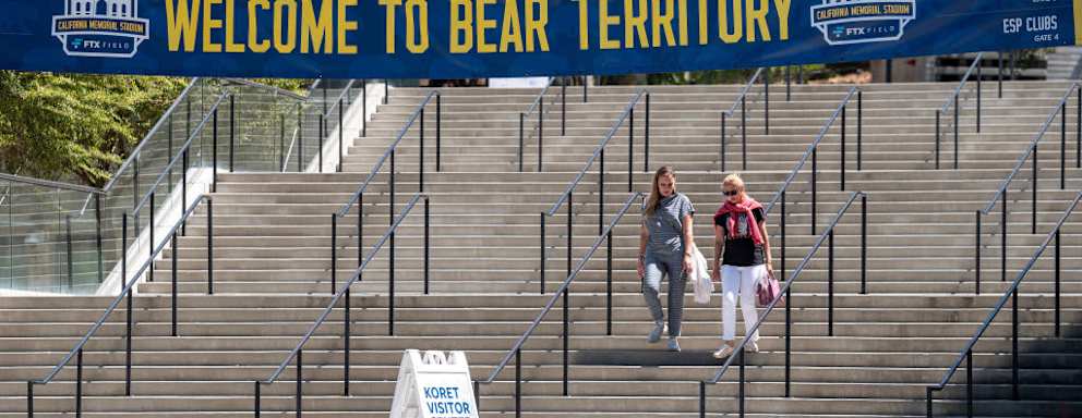 Students walk down the steps at the entrance to the California Memorial Stadium on the University of California campus in Berkeley, California.