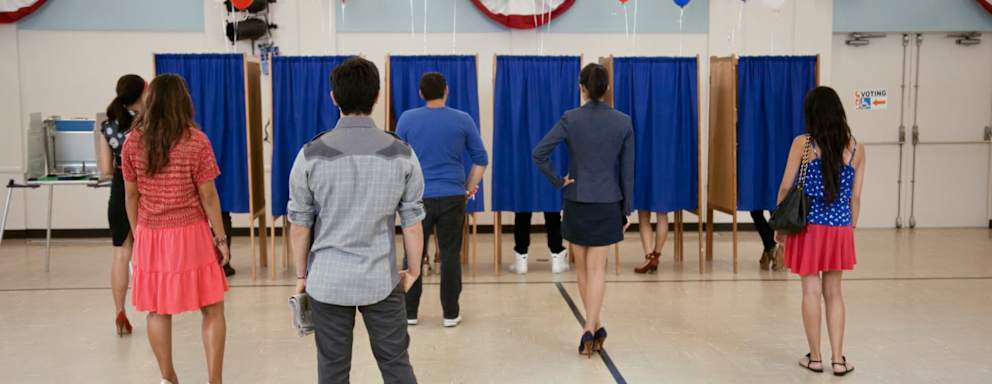 Voters waiting to vote in polling place