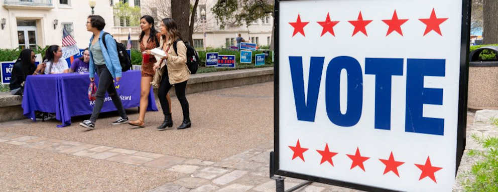 Students from the University of Texas in Austin walk in the square during a primary vote in Austin, Texas.