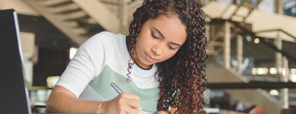 Latina student taking notes