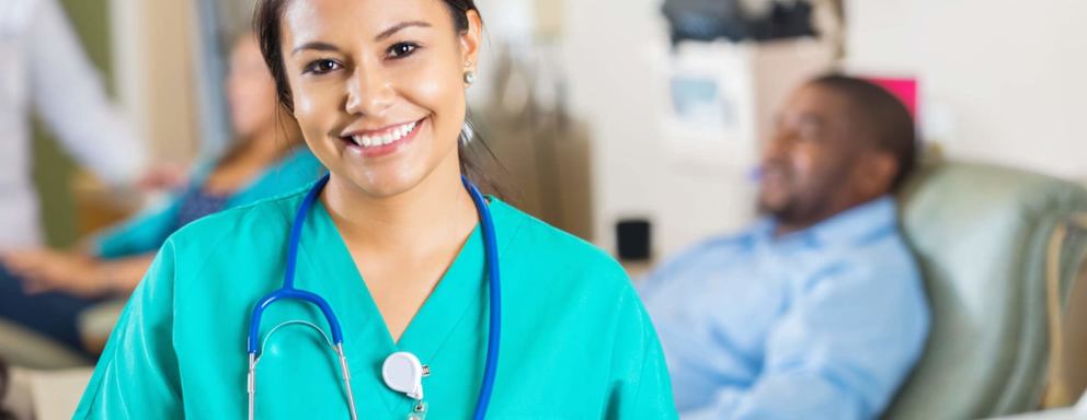 Hispanic nurse smiling in hospital room