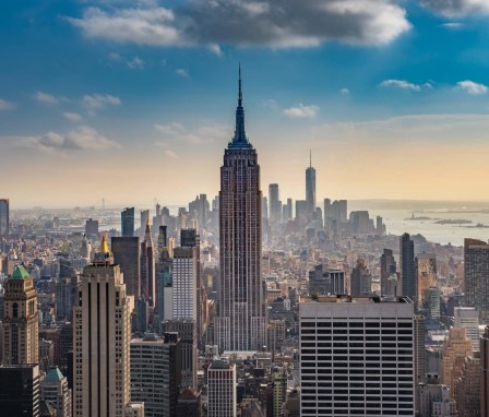 The Empire State Building in New York City, as seen from the rooftop of the Rockefeller Building, at sunset.